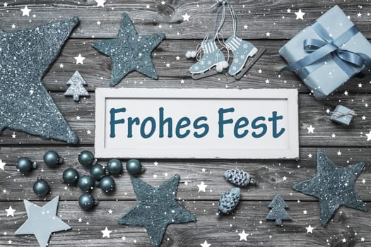 Greeting card for christmas with german text for merry christmas. Decoration in white and light blue in shabby chic style.