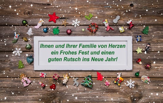 Christmas card with colorful decoration and german text merry christmas for your family and a happy new year.