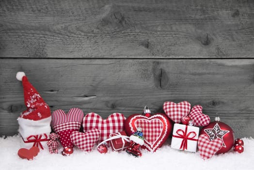 Red white checked christmas decoration on grey wooden shabby background.