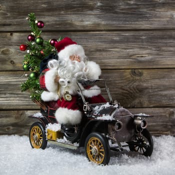Santa claus in rush with his car