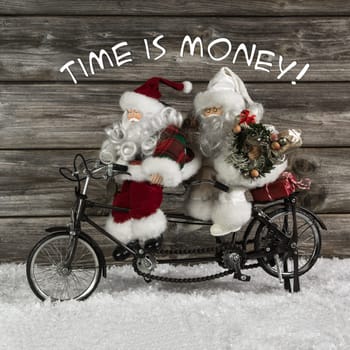 Time is money - santa claus team in rush for buying christmas presents. Funny photo in vintage style with an old tandem bike of tin.