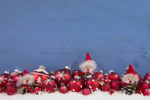 Wooden blue christmas background with red and white decoration. Also decorated with brownie.