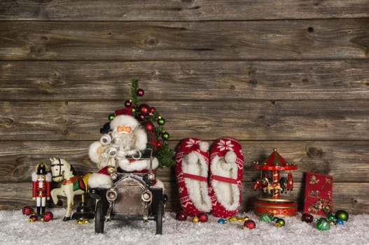 Nostalgic wooden christmas decoration with old toys on the background. Idea for a greeting card with Santa Claus.