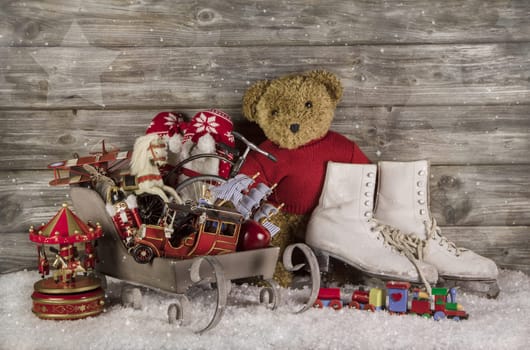 Old children toys on wooden background for christmas decoration in vintage style.