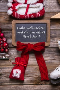 German merry christmas card with text - decorated in red, wood and white - country style.