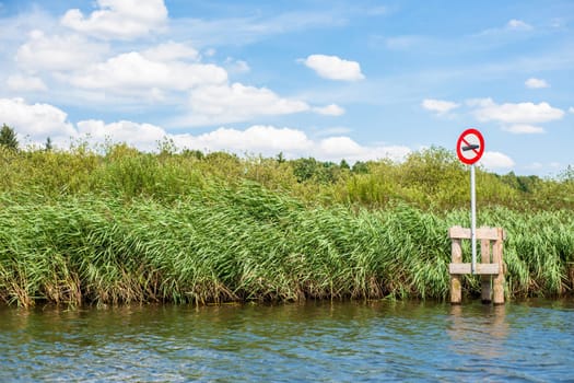 Lake scenery with a red no boating sign