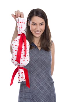 Isolated happy pretty woman holding a gift with red hearts in her hands.