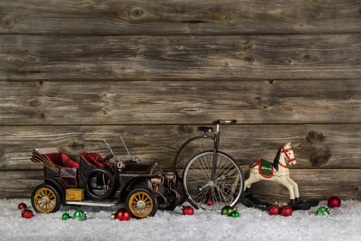 Old antique children toys of wood and tin for christmas decoration on wooden rustic background.