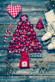 Christmas decoraion in red and white on wood in rustic vintage style with snowflakes.