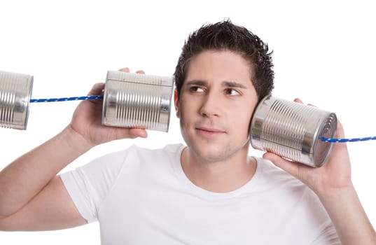 Isolated young man in white holding tin can. Communication or decision concepts.