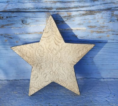 One old golden wooden christmas star for decoration.