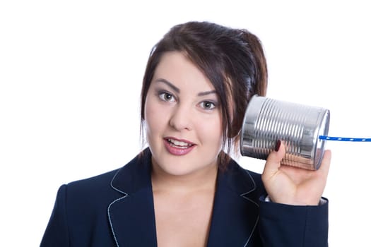 Stunned and nosy young businesswoman isolated over white holding a tin can for concepts in her hand.