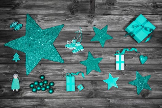 Christmas decoration in green or turquoise colors on wooden old shabby background with presents.