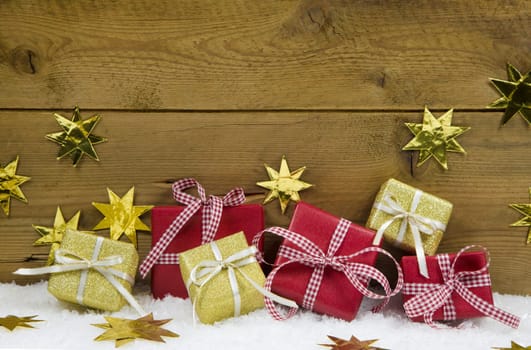 Christmas background with presents and gifts in gold and red for a greeting card.