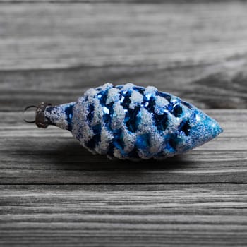 One old blue christmas ball for xmas decoration on wooden background.