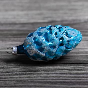 One old blue christmas ball for xmas decoration on wooden background.