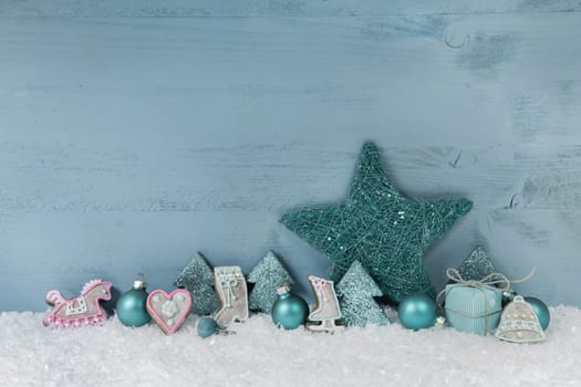 Winterly wooden blue or mint green christmas background with decoration.