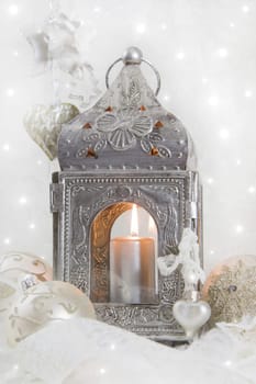 Christmas decoration with a latern in white and silver for a christmas card