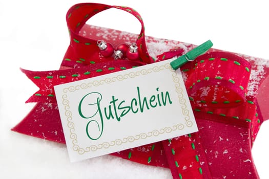 Red gift box and coupon with german text for christmas