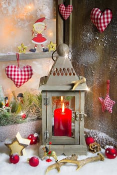 Rustic lantern with candlelights for christmas - classic in red and white for a greeting card