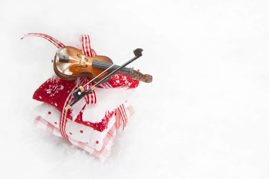 Three bean bag with ribbon and violin on white background for christmas