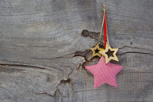 Top view of christmas decoration stars hanging on wooden background on wooden background