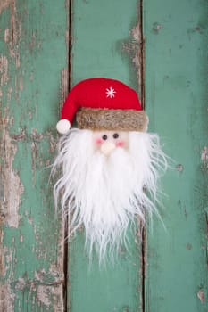 Close up of Santa head on wooden background for christmas