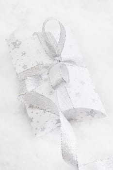 Close up of white present box with silver ribbon for christmas on white background