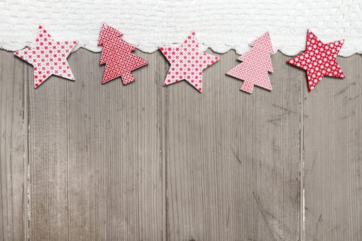 Top view of star and pine tree decoration with crochet strip on wooden background for christmas