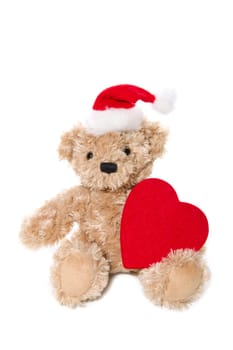 Christmas, teddy bear holding red heart wearing santa hat on isolated white background