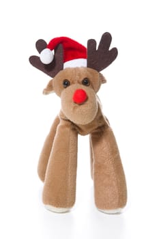 Isolated plush reindeer or elk with a santa or christmas hat for decoration