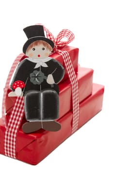 Stack of red Christmas presents with chimney sweeper isolated on white background - greetings for a happy new year