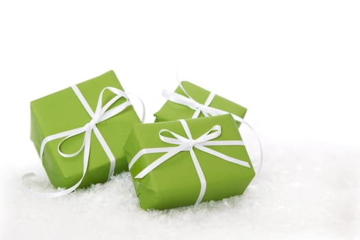 Three green gift boxes tied with white ribbon - present isolated for christmas or birthday or idea for a christmas card