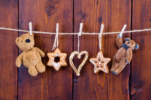 Close up of hanging gingerbread and teddy bear - rustic country christmas decoration