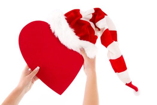 Woman holding red heart with santa hat and a heart for love in her hands