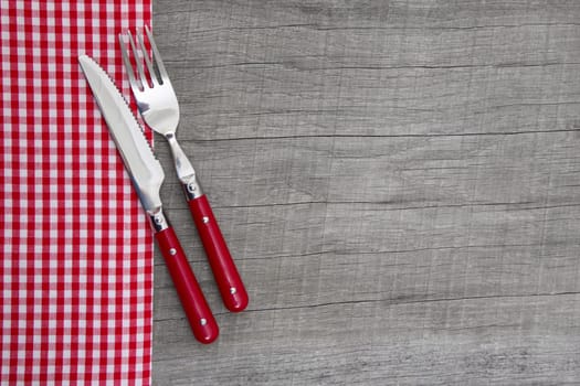 Knife and fork on wooden background for christmas, birthday, valentine's day, mother's day or for a greeting card - bavarian food or invitation