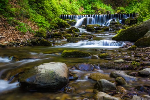 Beautiful waterfall landscape (Ukrainian Carpathian) in green forest