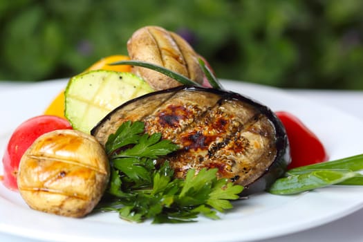 Grilled vegetables with mushrooms and greens (closeup, selective focus)
