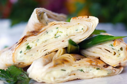 Roasted pancake with sheep cheese and greens (closeup, selective focus)