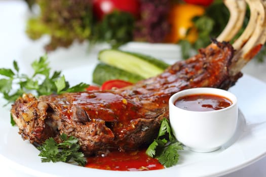 Lamb chops with greens and garnish (closeup, selective focus)