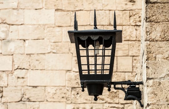 Vintage street lamp against a textured brick wall