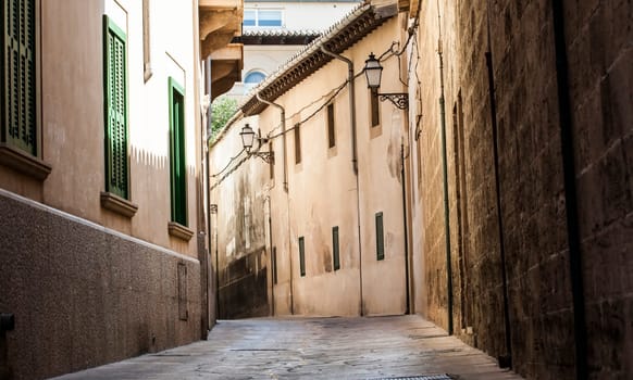Narrow street in old city of Palma de Mallorca, Spain