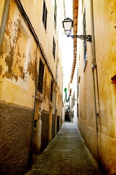 Narrow street in old city of Palma de Mallorca, Spain