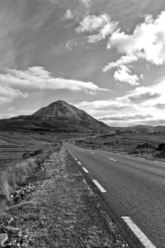 road to the Errigal mountains in black and white at county Donegal Ireland on a bright cloudy day