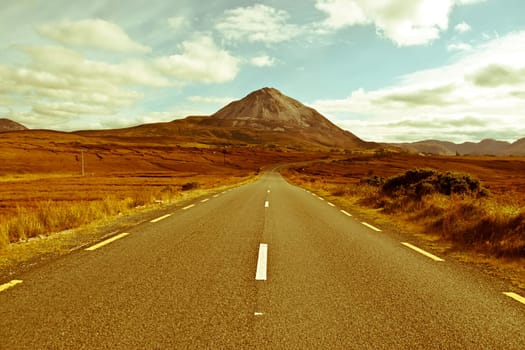 road to the Errigal mountains in county Donegal Ireland on a bright cloudy day
