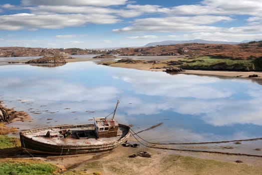 old fishing boat beached on a coastal beach in county Donegal, Ireland