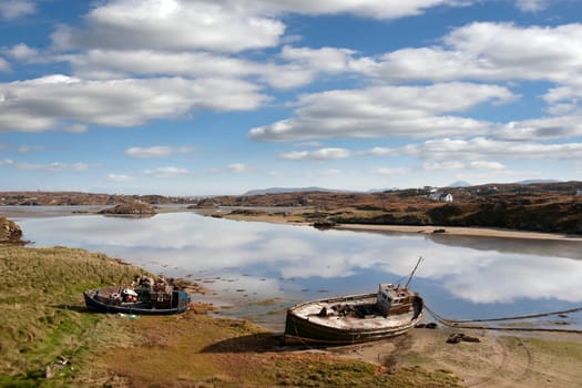 two old fishing boats beached on a coastal beach in county Donegal, Ireland