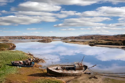 two old fishing boats beached on a coastal beach in county Donegal, Ireland