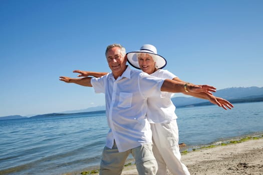 Mature couple having fun on ocean beach