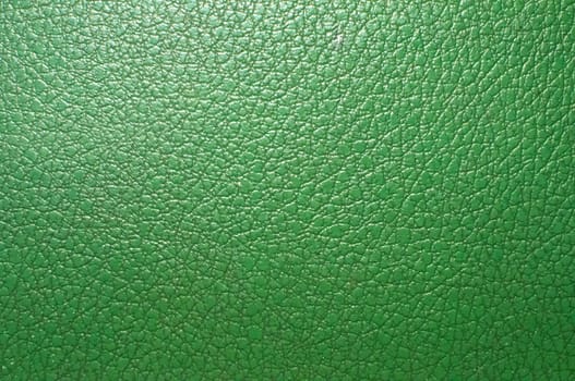 Green artificial leather surface closeup as background